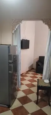 a living room with a refrigerator and a couch at Riad 05 in Marrakech