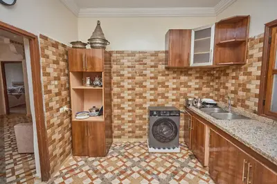 a kitchen with a sink and a washing machine at Dar Hma in Marrakech