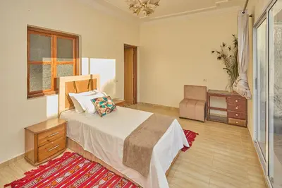 a bedroom with a bed and a dresser at Dar Hma in Marrakech