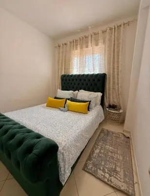 a bedroom with a bed with yellow pillows and a couch at Marrakech stay in Marrakech