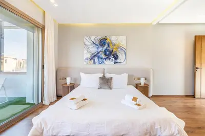 a bedroom with a large white bed with two towels on it at Villa Zineb Confort, design et sérénité in Marrakech