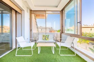 a balcony with white chairs and a table and a bench at Villa Zineb Confort, design et sérénité in Marrakech