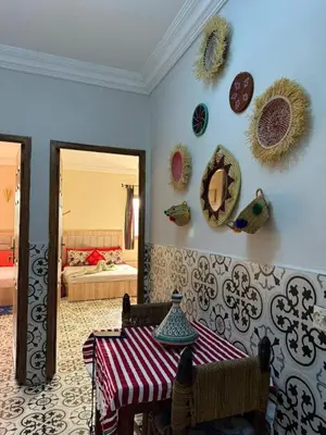 a dining room with a table and plates on the wall at traditional apartment in Marrakech