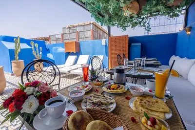 a table with breakfast food on top of a balcony at Riad Jowara in Marrakech