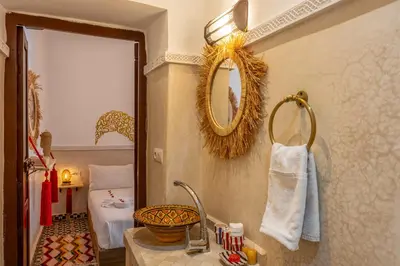 a bathroom with a sink and a mirror at Riad Jowara in Marrakech