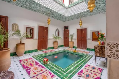 a swimming pool in a room with a ceiling at Riad Jowara in Marrakech