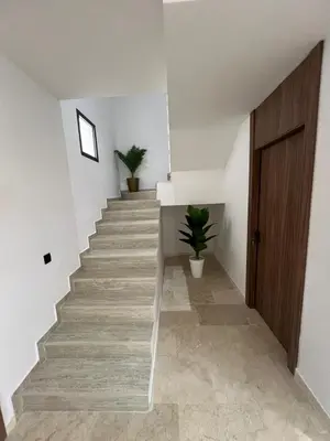 a staircase in a house with a wooden door at Duplex Menara Garden 2 in Marrakech