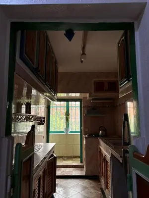 a kitchen with a door open to a kitchen with a counter at Oum rabiaa in Marrakech