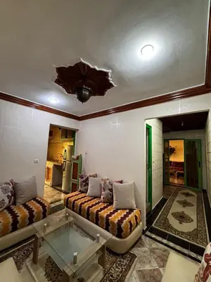 a living room with a couch and a glass table at Oum rabiaa in Marrakech