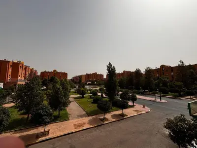 a view of a park with trees and buildings at Oum rabiaa in Marrakech