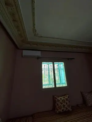 a room with a window and a bed with pillows at Oum rabiaa in Marrakech