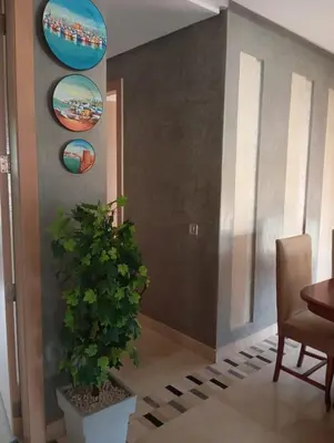 a dining room with a table and a potted plant at Appartement prestigia golf in Marrakech