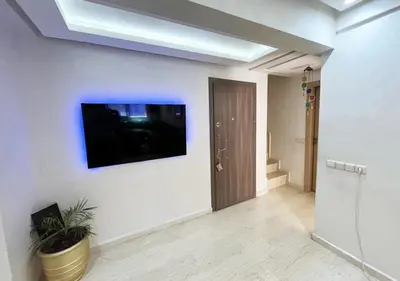 a living room with a flat screen tv on a wall at duplex prestige Gueliz in Marrakech