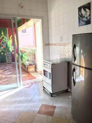 a kitchen with a stainless steel stove and refrigerator at Appartement Andalou in Marrakech