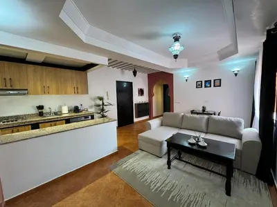 a living room with a couch and a table at Appartement typique Marrakech in Marrakech