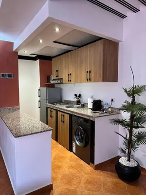 a kitchen with a sink and a dishwasher at Appartement typique Marrakech in Marrakech