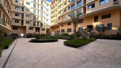 a courtyard of a apartment building with a courtyard sidx sidx sidx at Le Cocon 28 Spacieux & Stylé au Cœur de la Ville in Marrakech