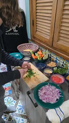 a group of people preparing food on a table at atelier de cuisine in Marrakech