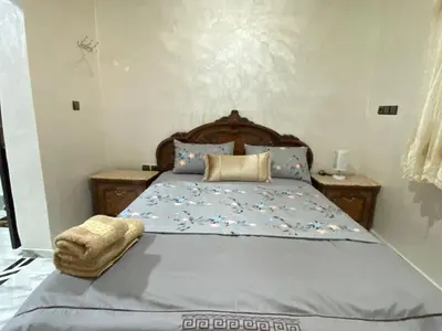 a bedroom with a bed with a blue comforter at Cosy, Calm Apartment - Wi-Fi, AC & NETFLIX in Marrakech