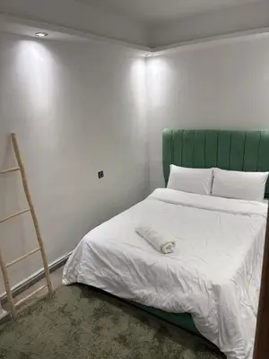 a bed with a green headboard in a room at Apartment with pool in Marrakech
