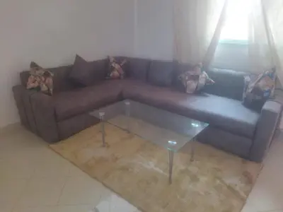 a living room with a couch and a glass table at Appartement Marrakech in Marrakech