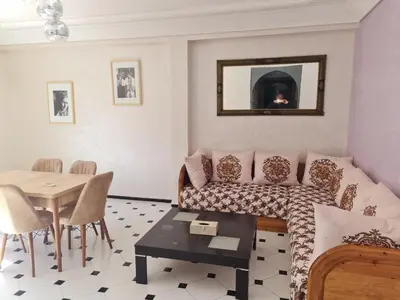 a living room with a couch and a table at Apart plein centre in Marrakech