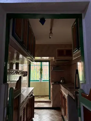a kitchen with a door open to a kitchen with a counter at Appartement a louer a massira 3 marrakech in Marrakech