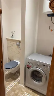 a washing machine in a bathroom with a toilet at Appart villa de luxe avec 5 piscines in Marrakech