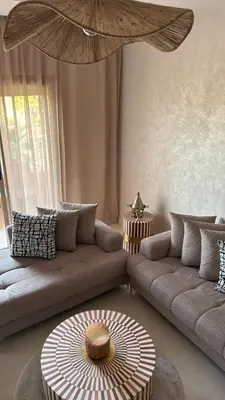 a living room with a couch and a table at Appart-by-Ily-Avenue M VI -Agdal in Marrakech