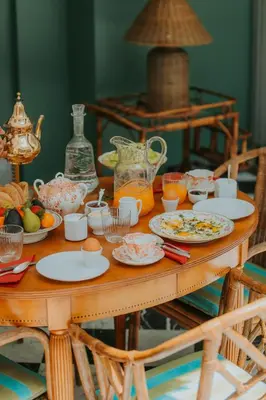 a wooden table with plates of food on it at Riad Palazzo Montefiore in Marrakech