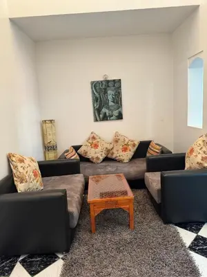 a living room with two couches and a coffee table at Al Qaria Syahia Duplex Moufid in Marrakech