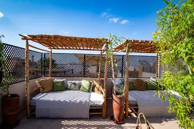 a gazebo with two beds on a patio at Riad Secret by Dar n alla in Marrakech