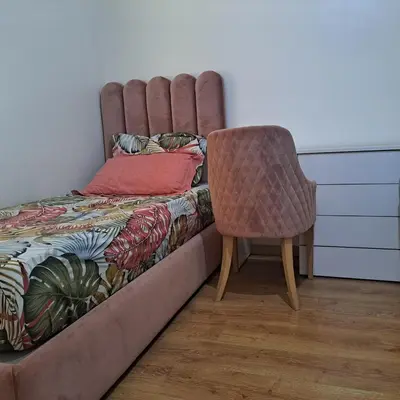 a bedroom with a bed and a chair at Luxury 2 Bedrooms Apartment in Marrakech