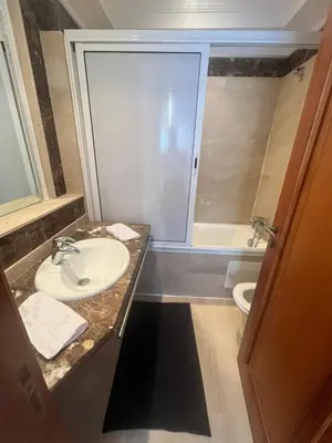 a bathroom with a sink and a toilet at Prestigieux Appart hivernage in Marrakech