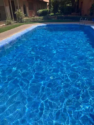 a large blue swimming pool with blue water at Prestigieux Appart hivernage in Marrakech