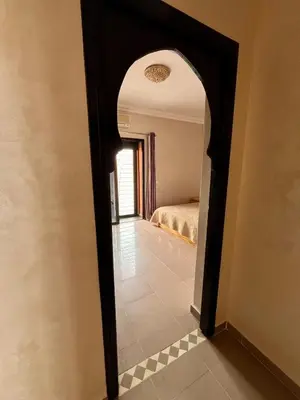 a hallway leading to a bedroom with a bed at Villa with private pool in Tamensourt