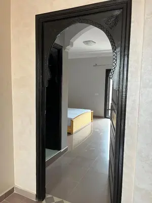 a mirror in a room with a bed in it at Villa with private pool in Tamensourt