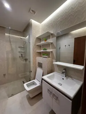 a bathroom with a toilet and a sink and a shower at appartement luxueux au centre vlle avec piscine in Marrakech