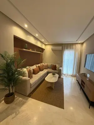 a living room with a couch and a table at Appartement de luxe à gueliz neuf et moderne in Marrakech