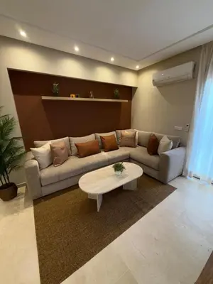 a living room with a couch and a coffee table at Appartement de luxe à gueliz neuf et moderne in Marrakech