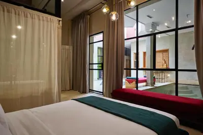a bedroom with a bed and a large window at Zen Zone Boutique Riad & Spa in Marrakech