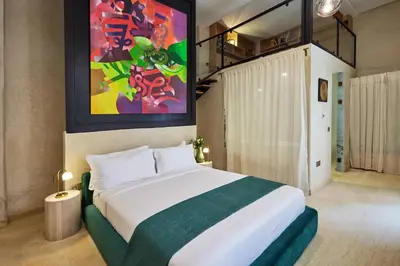 a bedroom with a large bed and a painting on the wall at Zen Zone Boutique Riad & Spa in Marrakech