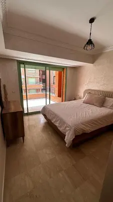 a bedroom with a large bed and a large window at Luxury & Cozy Apt in Hivernage in Marrakech
