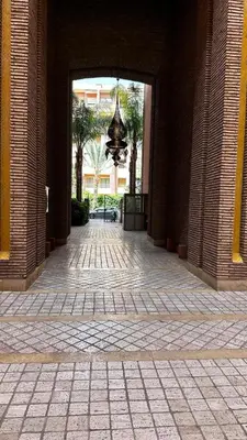 an entrance to a building with a chandelier in a hallway at Luxury & Cozy Apt in Hivernage in Marrakech