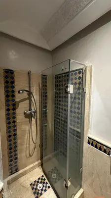 a shower with a glass door in a bathroom at Luxury & Cozy Apt in Hivernage in Marrakech
