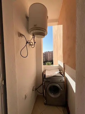 a laundry room with a light and a washing machine at Peaceful Marrakech Stay Cozy Well Located in Marrakech