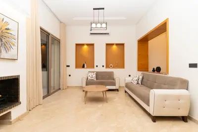 a living room with a couch and a fireplace at Villa Meraki in Marrakech