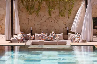 a living room with a couch and a swimming pool at Villa Tiaré Luxury, pool, staff and private cinema in Marrakech