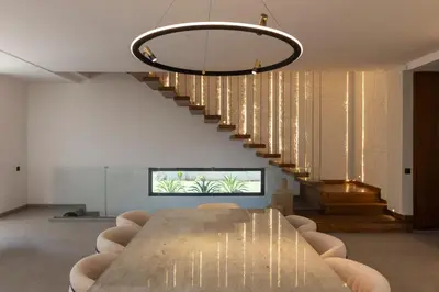 a dining room with a table and a staircase at Villa Tiaré Luxury, pool, staff and private cinema in Marrakech