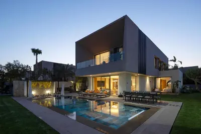 a large house with a swimming pool in front of it at Villa Tiaré Luxury, pool, staff and private cinema in Marrakech